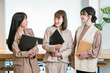 © buritora - Smiling businesswomen (working women, working mothers) lined up in an office.