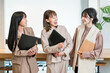 © buritora - Smiling businesswomen (working women, working mothers) lined up in an office.