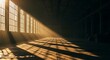 © masa - Golden rays of sunlight penetrate tall windows, dramatically illuminating an expansive, empty concrete industrial warehouse interior with profound shadows stretching across the floor