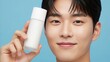 © Photo Moon - Skincare - Young Asian Man Holding White Blank Bottle Skincare Product With Clear Healthy Glowing Skin