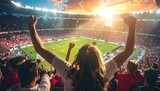 Sports fans cheer with hands raised celebrating a goal during a soccer match at a packed stadium during sunset with dramatic lighting illuminating the field