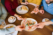 © djile - Friends sharing bruschetta and coffee at restaurant table