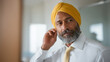 © forenna - Indian Sikh man in turban adjusts his dastar in office bathroom mirror before returning to corporate meeting, professional identity faith expression workplace, South Asian business professional reli
