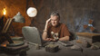 © stokkete - Prehistoric office worker having a bad headache