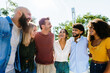 © Xavier Lorenzo - Group of diverse young friends laughing together outdoors. Cheerful people enjoying fun moments and strong community bonds in a sunny park. Friendship and lifestyle concept.