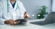 © Toowongsa - Doctor using tablet reviewing patient feedback rating interface with satisfaction icons representing healthcare service quality evaluation digital experience management modern medical system