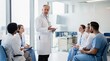 © JT Studio - A group of medical professionals engages in a discussion led by a senior doctor in a modern healthcare setting.