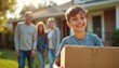 © miss irine - Happy boy carries box to new home. Smiling family follows him, happy about relocation and purchase of their residential property. Future ownership and belonging.