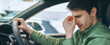 © Prostock-studio - A man is in a car with a worried expression on his face. He is sitting in the driver's seat and seems to be dealing with stress or anxiety. It is daytime outside.