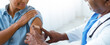 © Prostock-studio - A nurse is putting a bandage on a woman's arm after administering a vaccine in a medical clinic. The woman appears to have received a shot. The setting is bright and clinical.