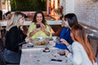 © Marcos - group of women friends having fun in a coffeeshop drinking a coffee cup