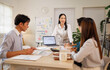 © David - Asian business team collaborating in informal office meeting