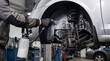 © Bano - A mechanic is servicing a car in a modern garage with specialized tools and equipment.