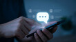 © HADI INCREDIBLE - person using smartphone with chat interface and people icons on screen