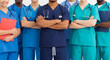 © Boss - Team of medical professionals in scrubs standing with arms crossed