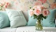 © Viktor - Pale pink roses in glass vase with aqua pillows. Soft floral wallpaper in pastel colors. Cozy home interior setting for relaxation and beauty.