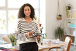 © Pixel-Shot - Female African-American interior designer with graphic tablet in office