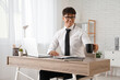© Pixel-Shot - Young businessman with coffee cup sitting at desk in office