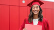© Eva Corbella - Celebrating graduation in a vibrant red cap and gown with a joyful smile in a modern urban setting