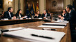 © val_webart - Government officials discussing policy in formal meeting room