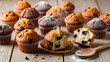 © MdRiyad - Assorted Freshly Baked Blueberry and Chocolate Chip Muffins on Wood