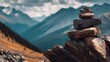 © Narumi - A weathered stone cairn sits against majestic, layered mountain peaks under a cloudy sky