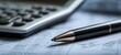 © Studio Nova - The Pen on Financial Document with Calculator in Shallow Depth of Field