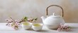 © Studio Nova - The white teapot with green tea cups and cherry blossoms on wooden table