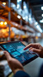 © Kateryna - Close up of a hand holding a tablet managing logistics and inventory control in a bright large cold chain storage warehouse the tablet showing temperature monitoring data and the