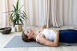 © SISMIZ - Woman practicing yoga breathing exercise for ultimate relaxation
