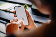 © DZ FILM/Stocksy - A woman using a mobile phone with a white screen