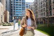 © Artcore Studio/Stocksy - Woman strolling in a sunny city