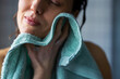 © OchreOchre/Stocksy - Woman Drying Face With Soft Towel After Shower