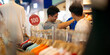 © Chaman Experience/Stocksy - Two smiling men enjoy browsing clothes together on a mall in Bangkok
