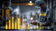 © WS Studio 1985 - Industrial Productivity Monitor: A focused worker in a hard hat and safety glasses reviews data on a tablet, surrounded by the hum of machinery and overlaid with glowing digital progress charts.