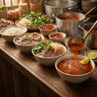 © Video80X - Vietnamese noodle soup preparation with ladle pouring broth into bowls garnished with lime, fresh herbs, bean sprouts, and red chili peppers on a wooden countertop with large pots