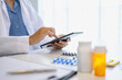 © Charlie's - Pharmacist using digital tablet and AI system for medication management using technology and AI innovation healthcare and smart pharmacy.