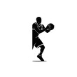 © Malik - Basketball player silhouette holds the ball firmly against the chest as if protecting the possession during a tight defensive play in a competitive game of professional team sports.