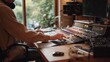 © fotofabrika - Person controls sound board in music studio during daylight
