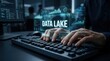 © Masque - Hands typing on a keyboard with a digital data lake concept overlaid in a futuristic interface.