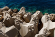 © 9parusnikov - Close up of concrete breakwater blocks by sea