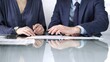 © rogerphoto - Business partners or lawyers are discussing contract papers during a meeting, negotiating and making decisions together. Business people concept, close up
