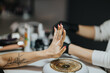 © qunica.com - Manicurist examines a client's pink painted nails during a salon manicure. Close-up view of the hand and nail care service with gloved technician.