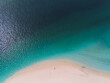 © AmazingAerialAgency - Aerial view of Farquhar Group with a person standing on the white sand beach beside turquoise and deep blue waters in Seychelles.