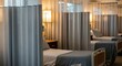 © Rehan - Hospital room privacy curtains providing division and comfort around a patient bed in a healthcare facility