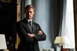 © olegganko - Man in Formal Wear Stands With Arms Crossed in a Stylish Indoor Setting During Evening Hours