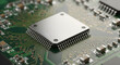 © graphicview35 - Close up of a silver microchip on a green printed circuit board with electronic components hardware engineering and technology concept