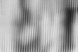 © GraphixWave - A grayscale image with vertical lines of varying shades and widths on a textured surface background