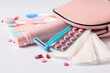 © Pixel-Shot - Cosmetic bag with different feminine hygiene items on white background