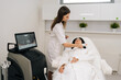 © dikushin - Relaxed middle-aged woman receiving modern hardware cosmetology procedure for facial skin rejuvenation from beautician, non invasive treatment for antiaging and skin tightening in beauty salon.